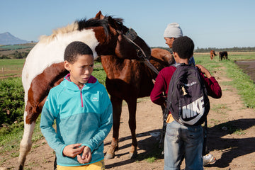 Tyrique Muller, Elnaldo Jafta and Matthew Plaatjies with Stallion and Queenie. Greyton